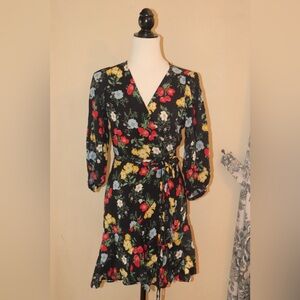 Flora wrap dress on black background.